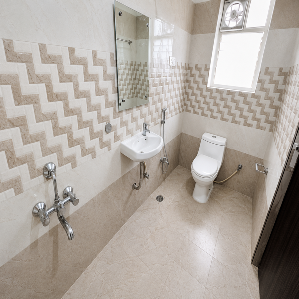 Modern bathroom, contemporary bathroom, luxury bathroom, stylish bathroom, clean bathroom, compact bathroom, toilet, western toilet, ceramic toilet, bathroom fixtures, wall mounted shower, shower head, water heater, electric geyser, wash basin, bathroom sink, chrome faucet, handheld bidet, health faucet, glass shelf, ventilation window, exhaust fan, patterned tiles, geometric tiles, grey tiles, white tiles, dark grey tiles, textured walls, tiled floor, marble effect, modern interiors, residential bathroom, home bathroom, bathroom design, interior design, sanitaryware, plumbing fixtures, bathroom accessories, minimalist bathroom, functional bathroom, bright bathroom, clean tiles, modern home, apartment bathroom, Indian bathroom, contemporary decor, utility space, indoor plumbing, sleek fixtures.